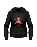 Black hoodie with a graphic and text on a white background. Hoodie from Cows Corner with a slogan on the front saying 'Mum’s My Toughest Coach and My Softest Hug!