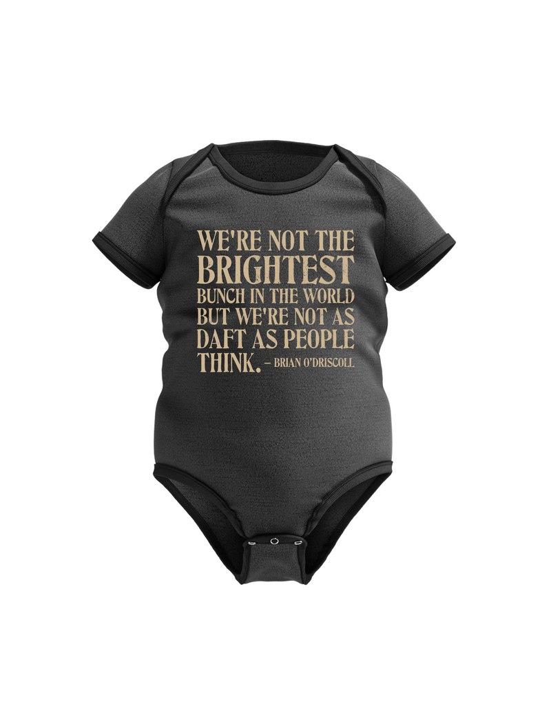 Black baby onesie with yellow text on a white background, with the slogan on the front 'We’re Not the Brightest Bunch in the World, but We’re Not As Daft as People Think – Brian O’Driscoll