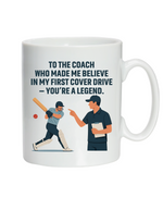 A white mug with the funny cricket coach saying on the front that reads 'To My Coach Who Made Me Believe in My First Cover Drive – You’re a Legend'