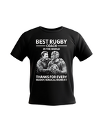 A black t-shirt with the funny rugby saying on the front that reads 'Best Rugby Coach in the World. Thanks for Every Muddy, Magical Moment'