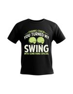 A black t-shirt with the funny tennis coach saying on the front that reads 'Thanks Coach You Turned My Swing Into Something Special'
