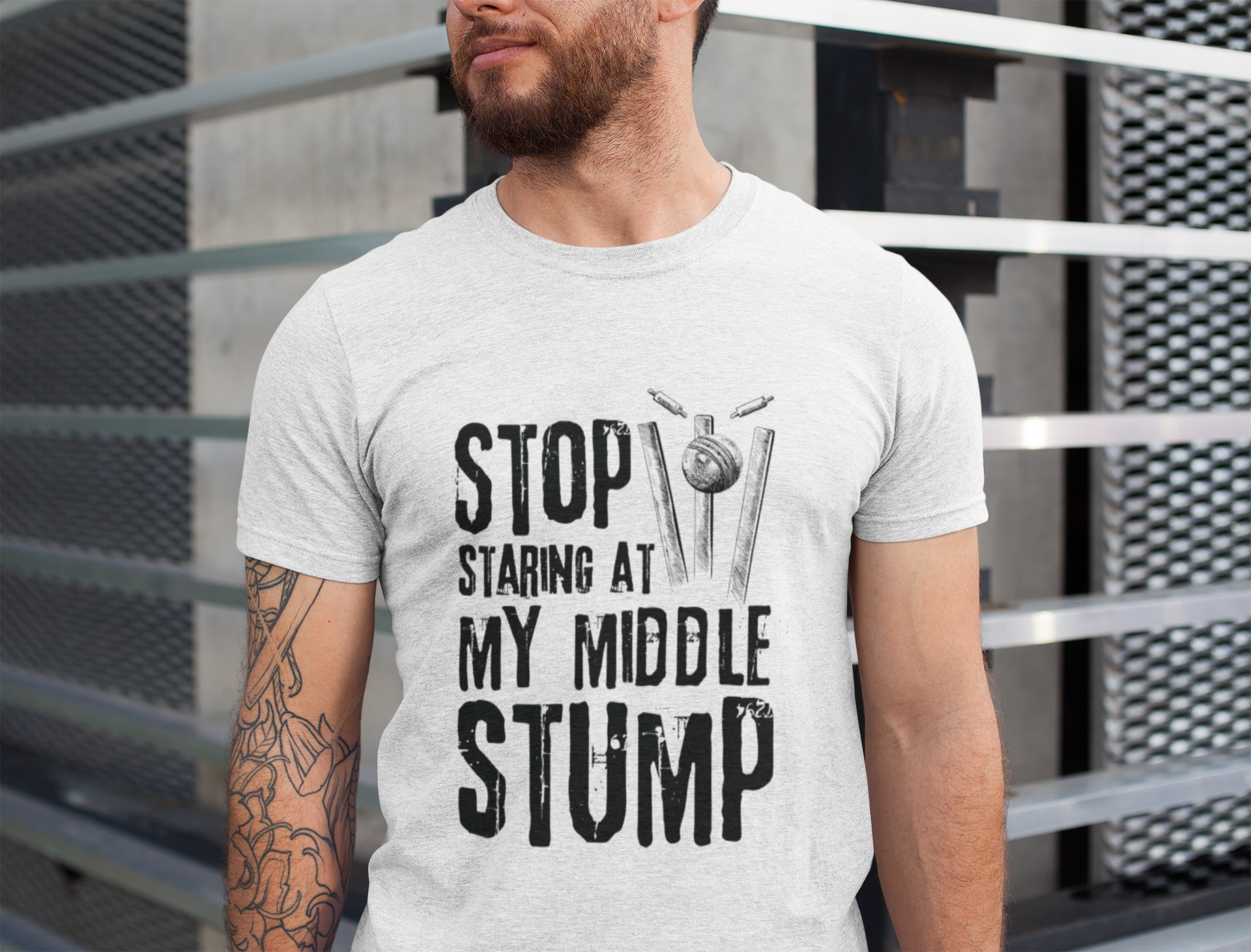 A man wearing a white t-shirt with Stop Staring At My Middle Stump on the front. A Funny Cricket T-Shirt, Premium Fabric, Multiple Adult Sizes