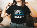 A lady wearing a black t-shirt with Pad Up, Shut Up And Try Not To Nick Off on the front. A Funny Cricket Tee, Premium Fabric, Multiple Adult Sizes
