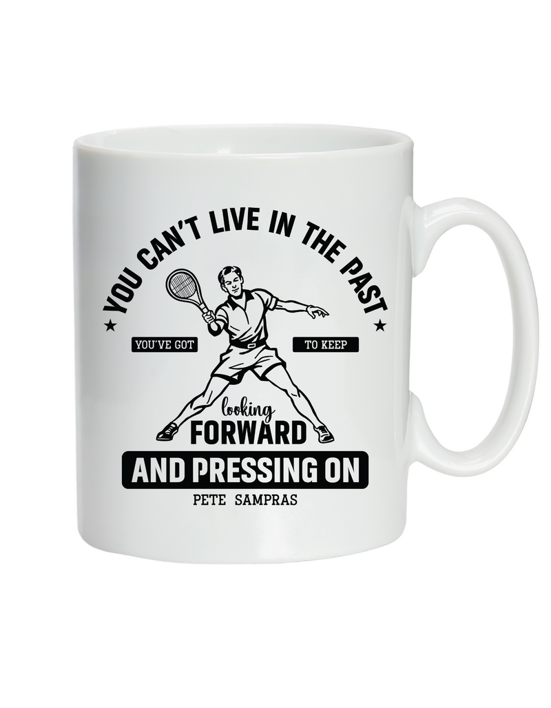 A white ceramic mug featuring the slogan on the front 'You Can’t Live in the Past, You’ve Got To Keep Looking Forward and Pressing On – Pete Sampras'