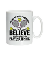 A white ceramic mug with tennis slogan on the front that reads 'I Wake Up Every Morning and Still Can’t Believe I Actually Make a Living Playing Tennis.'