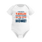 White baby onesie with colorful text on a white background, with a slogan on the front saying 'My Mum Tackles Everything on the Pitch and at Home!'