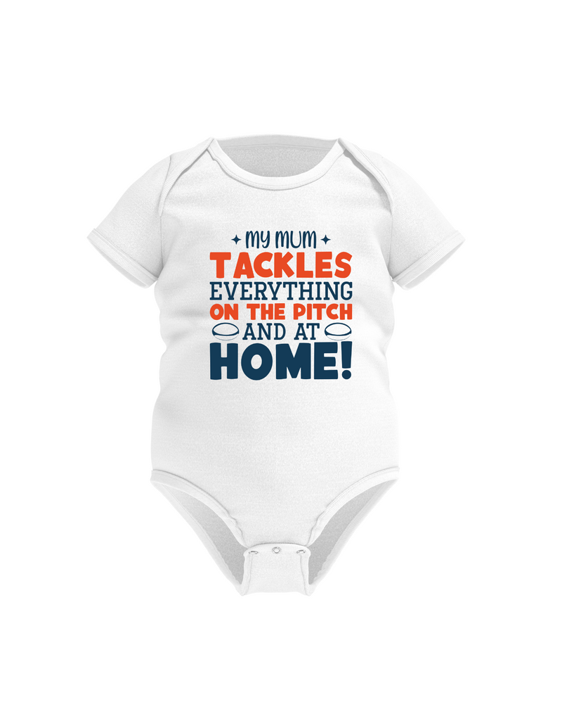 White baby onesie with colorful text on a white background, with a slogan on the front saying 'My Mum Tackles Everything on the Pitch and at Home!'