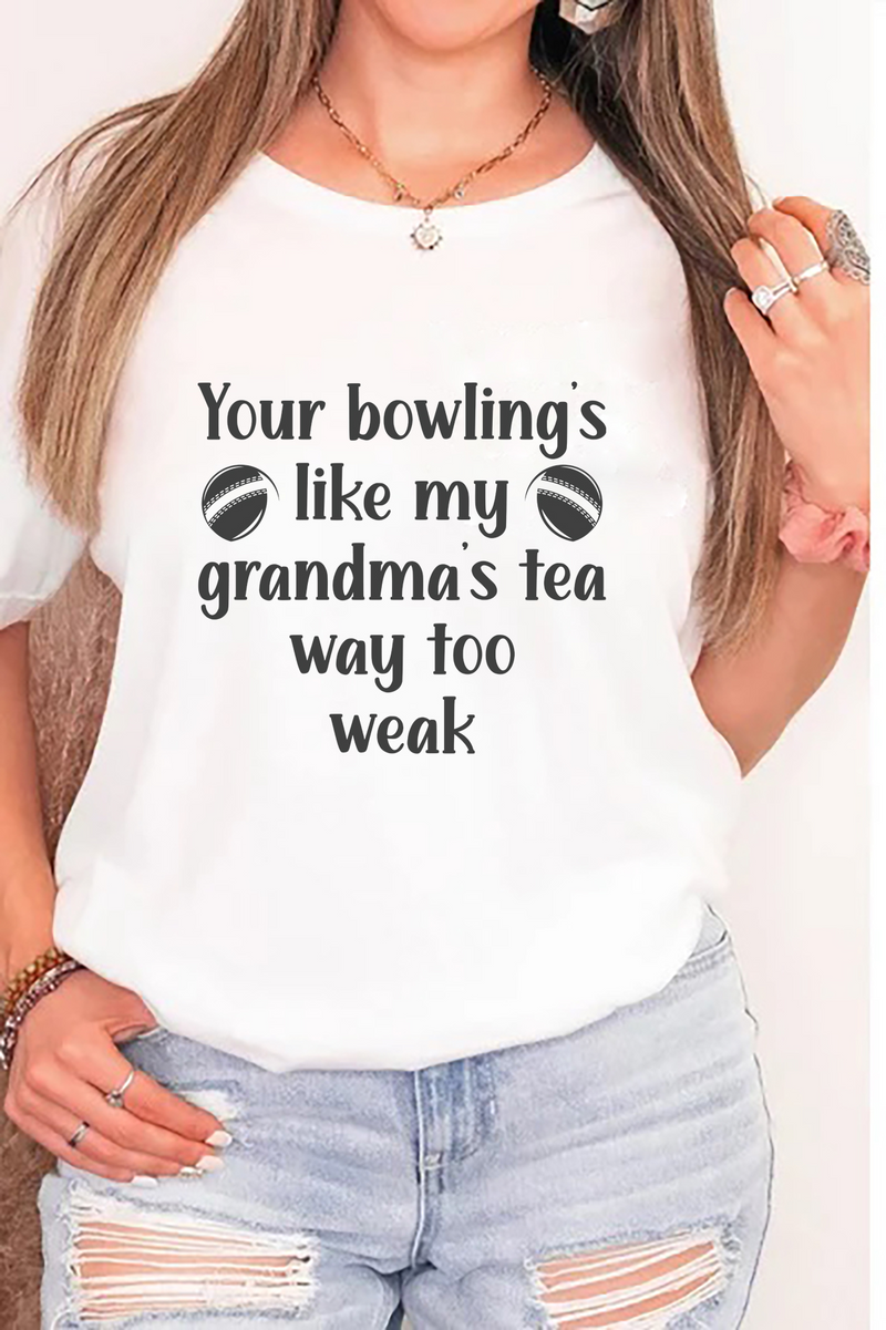 A lady wearing a white t-shirt with Your bowling is like my grandma's tea, way too weak on the front! A Funny Cricket T-Shirt, Premium Fabric, Multiple Adult Sizes