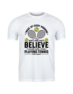 A white t-shirt with funny tennis slogan on the front that reads 'A white ceramic mug with tennis slogan on the front that reads 'I Wake Up Every Morning and Still Can’t Believe I Actually Make a Living Playing Tennis.'
