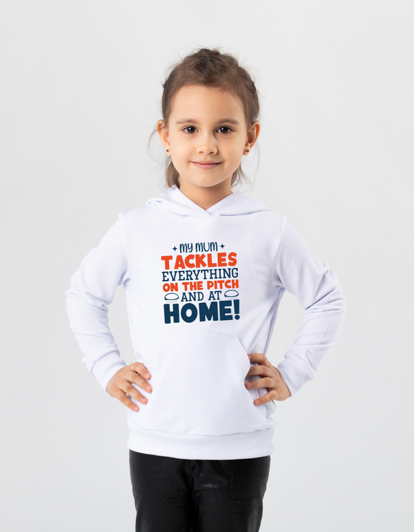Child wearing a white hoodie with text on a light gray background, with a slogan on the front saying 'My Mum Tackles Everything on the Pitch and at Home!'