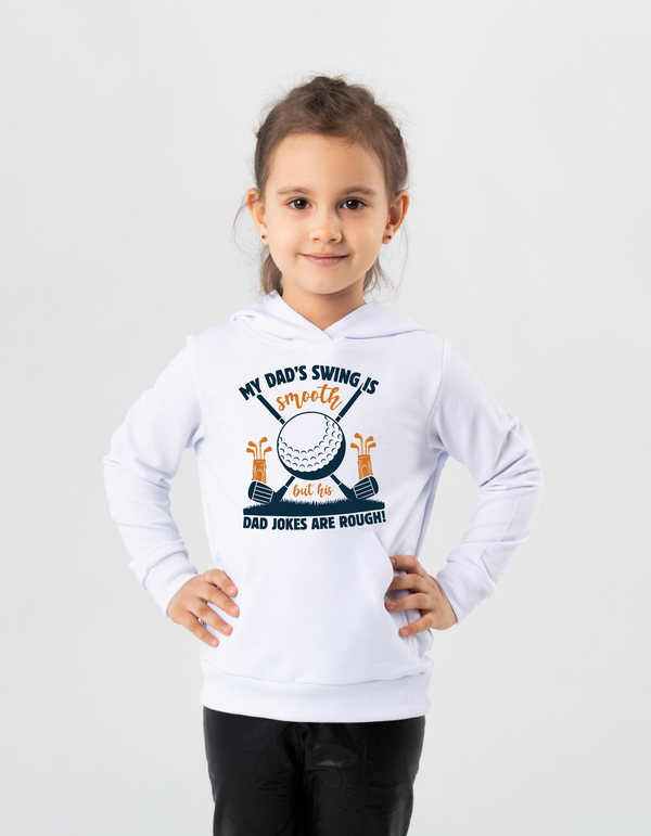 Child wearing a white hoodie with a graphic design on a light gray background with a Cows Corner slogan saying My dad's swing is smooth, but his jokes are rough.