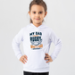 Child wearing a white hoodie with rugby-themed text on a light gray background, with a slogan on the front saying 'My Dad Plays Rugby. What’s Your Superpower?