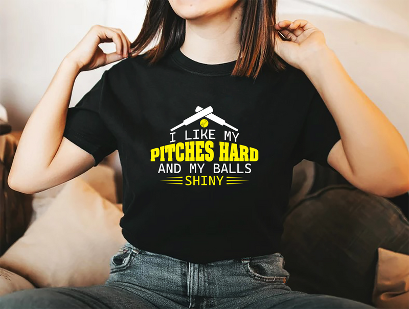 A lady wearing a black t-shirt with I Like My Pitches Hard And My Balls Shiny on the front! A Funny Cricket Tee, Premium Fabric, Multiple Adult Sizes