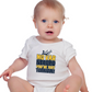 A a little baby wearing a white baby grow with the funny football slogan on the front saying 'No VAR Needed You’re Just Terrible'