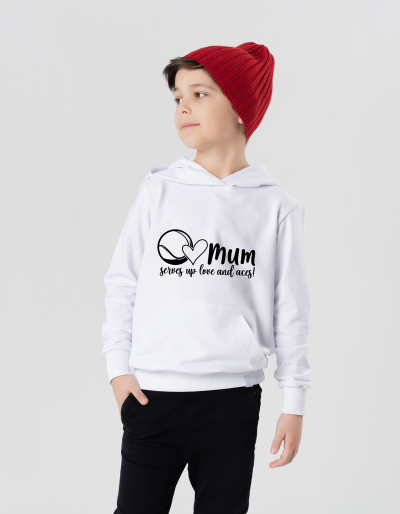A boy wearing a white hoodie with the lovely tennis slogan on the front that reads 'Mum Serves Up Love and Aces'