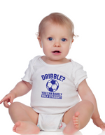 A little baby wearing a white baby grow with a funny football slogan on the front that reads 'Dribble You Can Barely Walk Straight!'