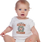 A baby wearing a white baby grow with the funny football slogan on the front that reads 'If Football Was Easy You’d Be Good at It'