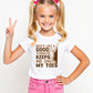 A little girl wearing a white t-shirt with Dads Like A Good Yorker, Keeps Me On My Toes on the front. A Funny Cricket T-Shirt, Premium Fabric, Multiple Junior Sizes, Perfect for Boys and Girls