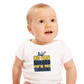 A a little baby wearing a white baby grow with the funny football slogan on the front saying 'No VAR Needed You’re Just Terrible'