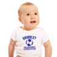 A little baby wearing a white baby grow with a funny football slogan on the front that reads 'Dribble You Can Barely Walk Straight!'