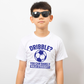 A little baby wearing a white t-shirt with a funny football slogan on the front that reads 'Dribble You Can Barely Walk Straight!'