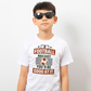 A little boy wearing a white T-shirt with the funny football slogan on the front that reads 'If Football Was Easy You’d Be Good at It'