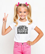 A little girl wearing a white t-shirt with Dads Like An Old Cricket Bat, Full Of Stories But Still In The Game on the front! A Funny Cricket Tee, Premium Fabric, Multiple Junior Sizes, Perfect for Boys and Girls
