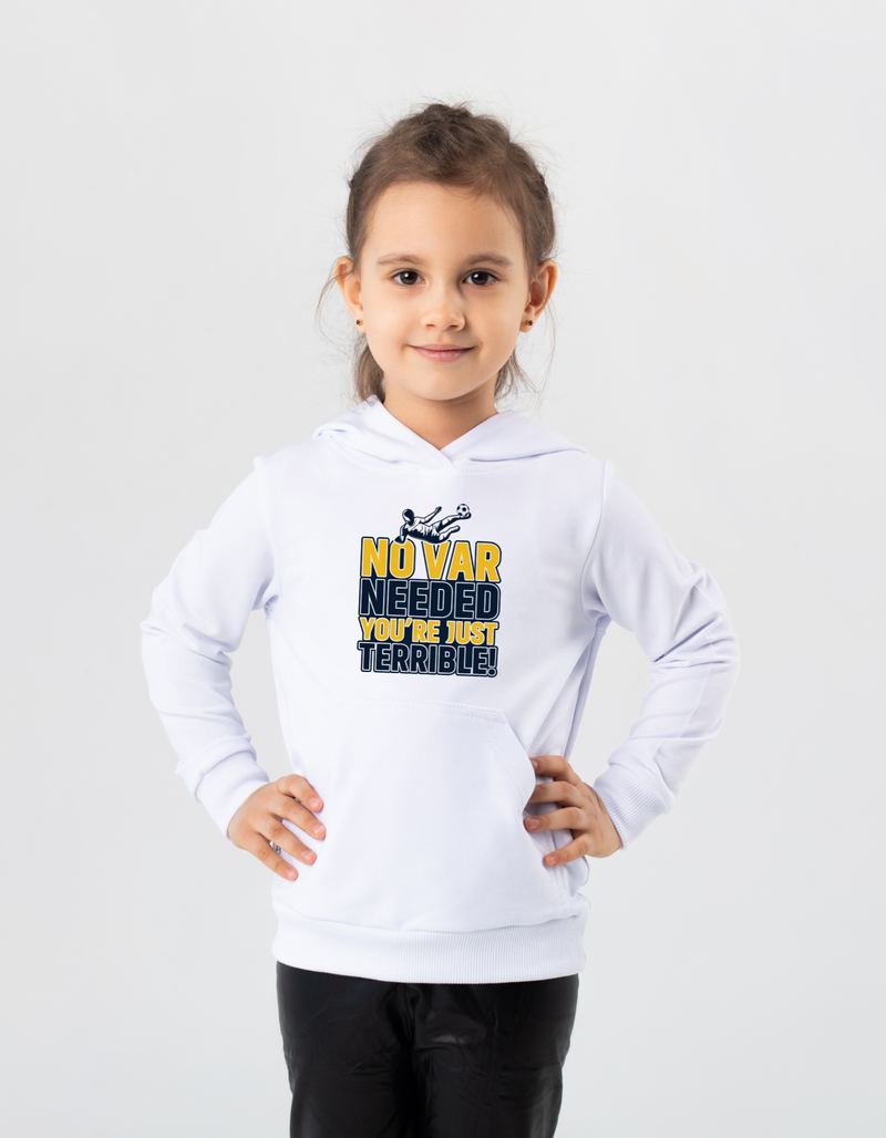A little girl wearing a white t-shirt with the funny football slogan on the front that reads 'No VAR Needed You’re Just Terrible'