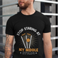 A man wearing a black t-shirt with Stop Staring At My Middle Stump on the front. A Funny Cricket T-Shirt, Premium Fabric, Multiple Adult Sizes