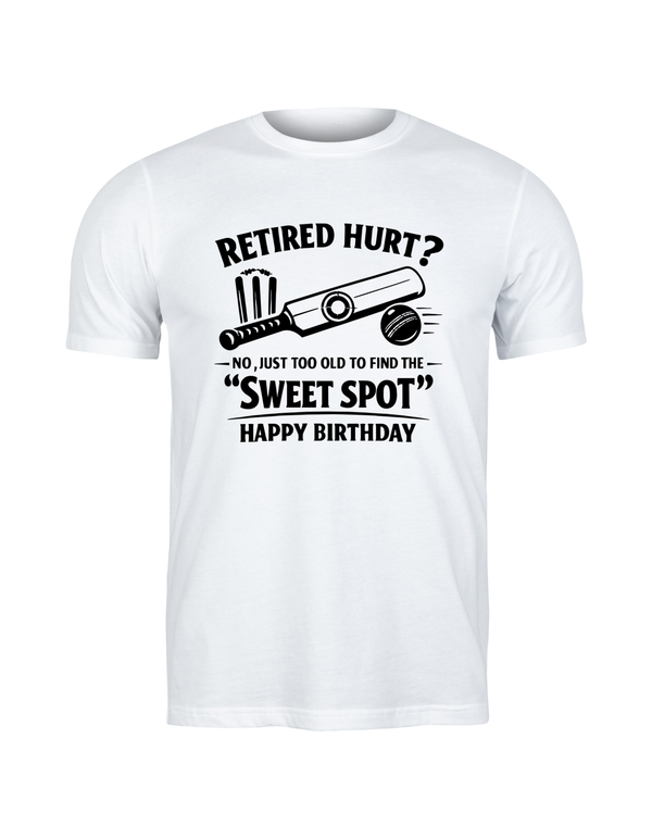 White t-shirt with humorous birthday message and graphic on a white background. This is a Cows Corner t-shirt with the funny cricket birthday slogan 'Retired Hurt? No, just too old to find the 'Sweet Spot' Happy Birthday'. Cows Corner gifts are perfect for sport-mad fans, these gifts work brilliantly for birthdays, new baby celebrations, Father’s Day, Mother’s Day, Christmas, anniversaries, thank you gifts, end-of-season team awards, graduations, retirements, and just-because moments 