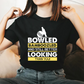 A lady wearing a black t-shirt with Bowled & Bamboozled and Still Looking Better Than You on the front. A Funny Cricket T-Shirt, Premium Fabric, Multiple Adult Sizes