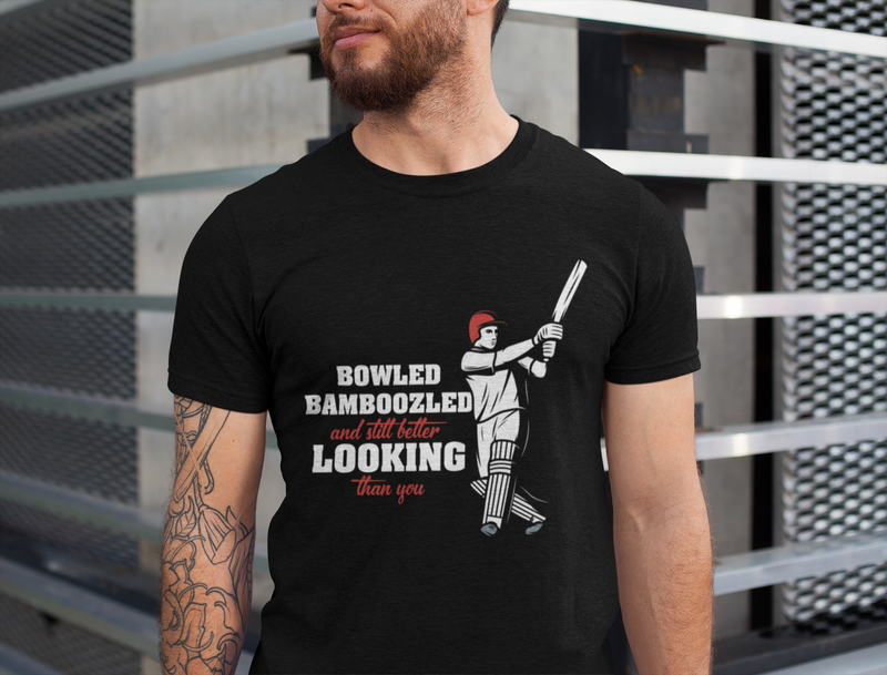 A man wearing a black t-shirt with Bowled & Bamboozled and Still Looking Better Than You on the front. A Funny Cricket T-Shirt, Premium Fabric, Multiple adult Sizes