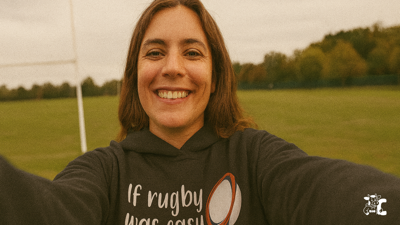 Person wearing a hoodie with 'If rugby was easy' text on a sports field showcasing Cows Corner product