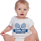 A little baby wearing a white baby grow with the funny tennis slogan on the front that reads 'Game, Set, Mismatch'