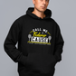 A man wearing a black hoodie with the funny tennis slogan on the front that reads 'Call Me Federer ’Cause I Just Schooled You'