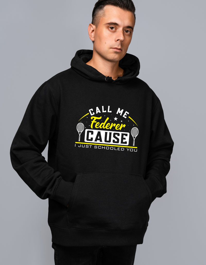 A man wearing a black hoodie with the funny tennis slogan on the front that reads 'Call Me Federer ’Cause I Just Schooled You'