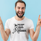 A man  wearing a white t-shirt with a funny tennis slogan on the front that reads 'This Court Ain't Big Enough For Your Excuses'