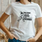 A lady wearing a white t-shirt with a funny tennis slogan on the front that reads 'This Court Ain't Big Enough For Your Excuses'