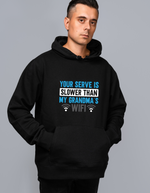 A man wearing a black hoodie with the funny tennis slogan on the front which reads 'Your Serve Is Slower Than My Grandma's Wifi'