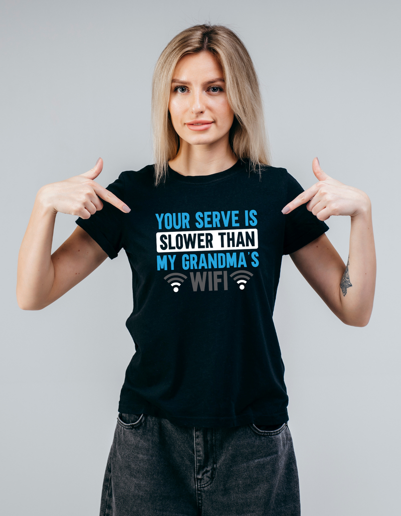A lady wearing a black t-shirt with the funny tennis slogan on the front which reads 'Your Serve Is Slower Than My Grandma's Wifi'