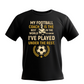Black t-shirt with yellow text and graphics on a white background, with Cows Corner slogan saying, My football coach is the best in the world, I'd know I've played under the rest.