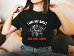 A lady wearing a black t-shirt with I Like My Balls Red And Hard on the front. A Funny Cricket T-Shirt, Premium Fabric, Multiple Adult Sizes