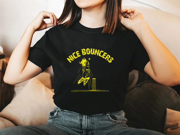 A lady wearing a black t-shirt with Nice Bouncers on the front! A Funny Cricket T-Shirt, Premium Fabric, Multiple Adult Sizes
