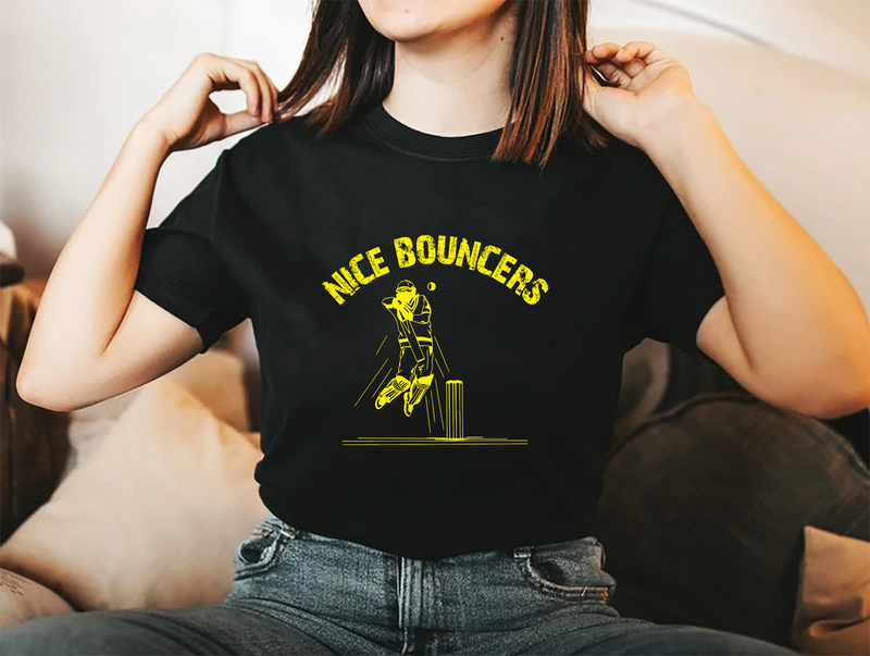 A lady wearing a black t-shirt with Nice Bouncers on the front! A Funny Cricket T-Shirt, Premium Fabric, Multiple Adult Sizes
