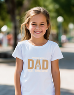 A girl wearing a white t-shirt with the funny tennis slogan on the front that reads 'Tennis with Dad, BEST. TIME. EVER'