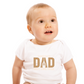A baby wearing a white baby grow with the funny tennis slogan on the front that reads 'Tennis with Dad, BEST. TIME. EVER'