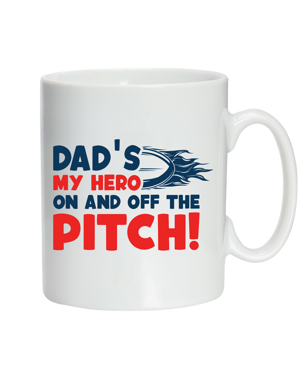 White mug with text 'Dad's my hero on and off the pitch' in blue and red on a white background with the Cows Corner slogan saying Dad's my hero on and off the pitch