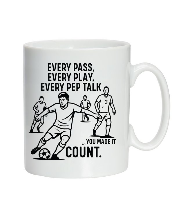 White mug with soccer-themed design and text on a white background, with Cows Corner slogan saying, Every pass, every play, every pep talk, you made it count.