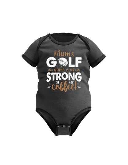 Black baby onesie with golf-themed text on a white background with a Cows Corner slogan saying Mums golf game is as strong as her coffee.