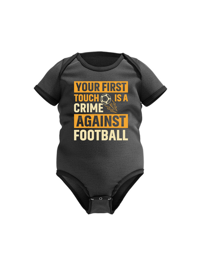 A black baby grow with the funny football slogan on the front that reads 'Your First Touch Is a Crime Against Football'